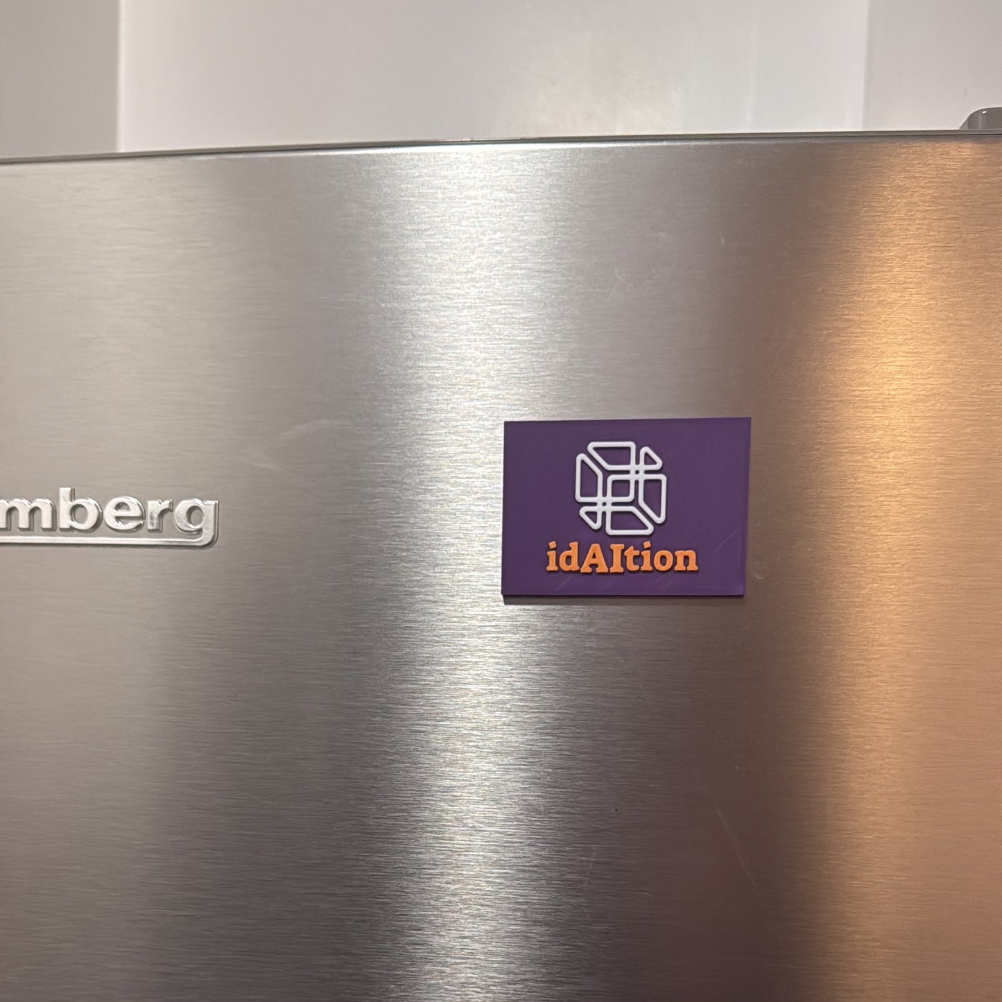 Stainless steel appliance with a logo on the door