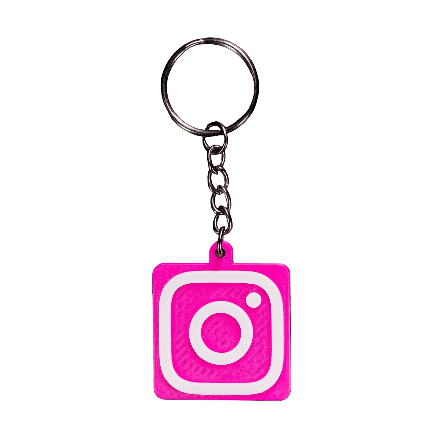 Keychain with pink instagram logo featuring a white circle on a black background
